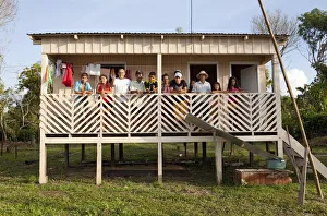 South America, Brazil, Amazonas, Gero Mesquita and a caboclo family stand on the balcony South America, Brazil, Amazonas, Gero Mesquita and a caboclo family stand on the balcony