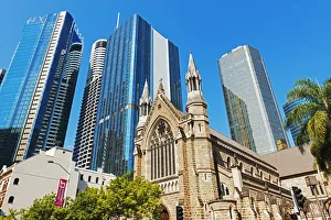 St Stephens Cathedral dwarfed by glass skyscrapers, Brisbane, Queensland, Australia St Stephens Cathedral dwarfed by glass skyscrapers, Brisbane, Queensland, Australia