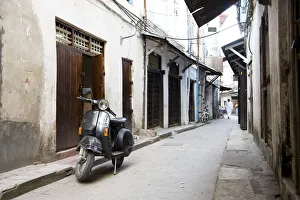Street scene in Stone Town with moped, Unguja Island, Zanzibar archipelago, Tanzania Street scene in Stone Town with moped, Unguja Island, Zanzibar archipelago, Tanzania