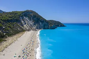 Sunshades on Milos Beach in summer. Agios Nikitas, Lefkada, Ionian Islands region Sunshades on Milos Beach in summer. Agios Nikitas, Lefkada, Ionian Islands region