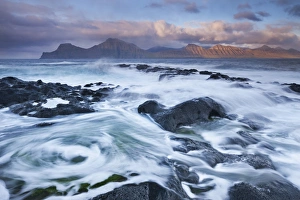 Surging waves break over the rocky shores at Gjogv on the island of Eysturoy, Faroe Islands Surging waves break over the rocky shores at Gjogv on the island of Eysturoy, Faroe Islands