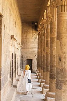 toursit walking through the Temple of Philae on an island in Lake Nasser, Nile River toursit walking through the Temple of Philae on an island in Lake Nasser, Nile River