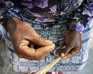 A traditional basket weaver in Maun, Botswana A traditional basket weaver in Maun, Botswana