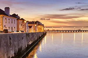 The traditional fishing village of Alcochete at sunset, spreading along the river Tagus The traditional fishing village of Alcochete at sunset, spreading along the river Tagus