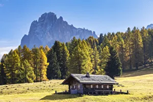 A traditional hut with the Sassolungo in the background A traditional hut with the Sassolungo in the background
