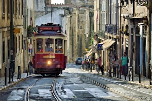 A tramway in Alfama district with the Motherchurch (Se Catedral) in the background