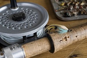 UK. A salmon fly stuck into the cork handle of a fly fishing rod UK. A salmon fly stuck into the cork handle of a fly fishing rod