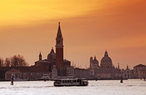 Venice, Veneto, Italy; A vaporetto crossing the Bacino di San Marco between the churches of Santa Maria della Salute Venice, Veneto, Italy; A vaporetto crossing the Bacino di San Marco between the churches of Santa Maria della Salute