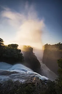 The Victoria Falls depicted at sunrise from Devils Cataract, in Zimbabwe side The Victoria Falls depicted at sunrise from Devils Cataract, in Zimbabwe side