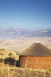 Village hut with Cathedral Peak in background, Ukhahlamba-Drakensberg Park, KwaZulu-Natal Village hut with Cathedral Peak in background, Ukhahlamba-Drakensberg Park, KwaZulu-Natal