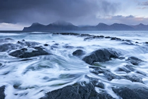 Waves crash against the black basalt rocky shores of Gjogv, Eysturoy, Faroe Islands Waves crash against the black basalt rocky shores of Gjogv, Eysturoy, Faroe Islands