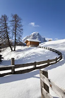 Winter snow covered mountain hut in front of Sassolungo mountain (3181m), Val Gardena Winter snow covered mountain hut in front of Sassolungo mountain (3181m), Val Gardena