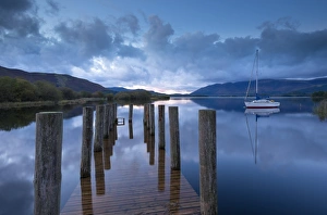 Wooden jetty and yacht on Derwent Water near Lodore, Lake District, Cumbria, England Wooden jetty and yacht on Derwent Water near Lodore, Lake District, Cumbria, England