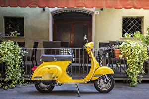 Yellow Vespa in Modena historic city. Modena old town, Emilia Romagna, Italy Yellow Vespa in Modena historic city. Modena old town, Emilia Romagna, Italy