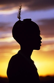 A young Dassanech boy silhouetted against the evening A young Dassanech boy silhouetted against the evening