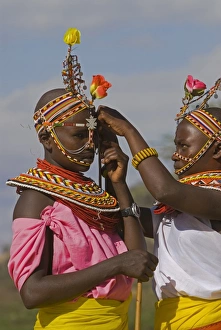 Two young Samburu girls help each other preparing for a celebration Two young Samburu girls help each other preparing for a celebration