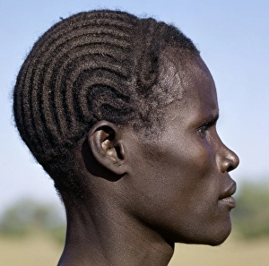 A young Turkana man with a braided hairstyle A young Turkana man with a braided hairstyle