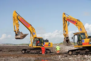 Construction workers working on the foreshore of the Solway Firth near Workington Construction workers working on the foreshore of the Solway Firth near Workington