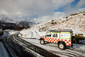 A landrover belonging to the Langdale Ambleside Mountain Rescue Team in winter snow in front of the Langdale Pikes A landrover belonging to the Langdale Ambleside Mountain Rescue Team in winter snow in front of the Langdale Pikes
