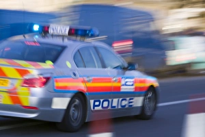 A police car speeding through the streets of London A police car speeding through the streets of London