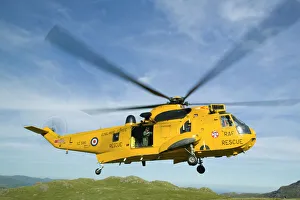 RAF Sea King Helicopter about to land on Crinkle Crags in the Lake district to evacuate an injured walker being treated RAF Sea King Helicopter about to land on Crinkle Crags in the Lake district to evacuate an injured walker being treated