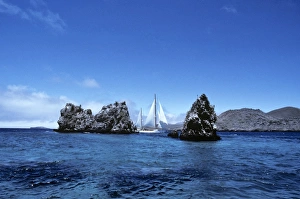 Yacht Aspasia Alpha sailing past Devils Crown, off Punta Cormorant Yacht Aspasia Alpha sailing past Devils Crown, off Punta Cormorant