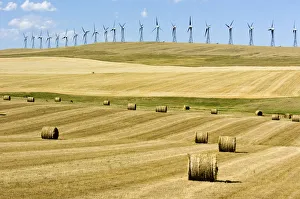 Canada, Alberta, Cowley Wind turbines and hay bales just after the harvest near Cowley Canada, Alberta, Cowley Wind turbines and hay bales just after the harvest near Cowley