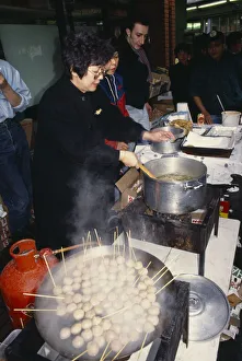 ENGLAND, London, Chinese New Year Women cooking on street stall during New Year ENGLAND, London, Chinese New Year Women cooking on street stall during New Year