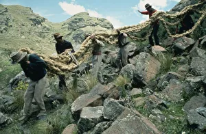 PERU Apurimac Gorge Men from the Chumbivilcas hills carrying length of thick rope made PERU Apurimac Gorge Men from the Chumbivilcas hills carrying length of thick rope made