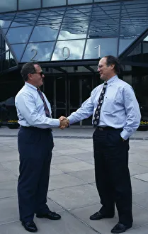 USA, Florida, Orlando Two businessmen in conversation shaking hands outside modern USA, Florida, Orlando Two businessmen in conversation shaking hands outside modern