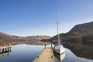 Yacht moored at a jetty on Lake Ullswater, Place Fell on right, Glenridding Yacht moored at a jetty on Lake Ullswater, Place Fell on right, Glenridding