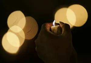 An activist holds a candle during celebrations of the International Day of Peace in An activist holds a candle during celebrations of the International Day of Peace in