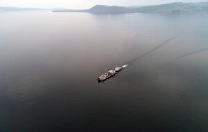 Russia Collection: Aerial view shows a ferry transporting passengers and vehicles across the Yenisei