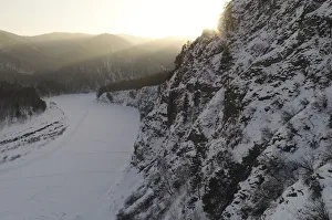 An aerial view shows the ice-covered Mana River in the Siberian Taiga area during sunset An aerial view shows the ice-covered Mana River in the Siberian Taiga area during sunset