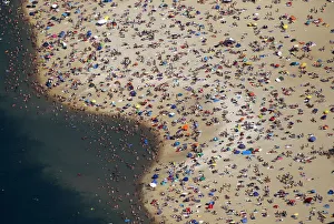 An aerial view shows people at a beach on the shores of the Silbersee lake on a hot An aerial view shows people at a beach on the shores of the Silbersee lake on a hot