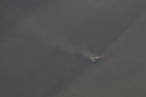 An aerial view shows a tractor plowing a field near Boryspil An aerial view shows a tractor plowing a field near Boryspil