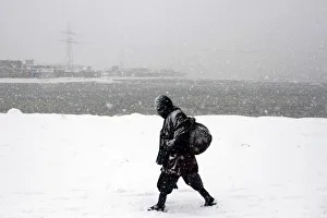An Afghan man walks during a snowy day in Kabul An Afghan man walks during a snowy day in Kabul