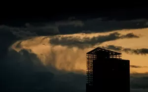 Images Dated 21st April 2018: An aircraft flies past a building under construction on a stormy evening in Moscow