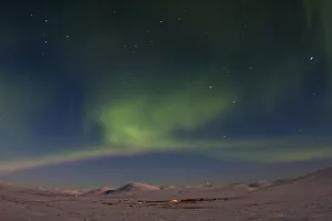 The aurora borealis is seen on Beam Road above snow-covered tundras near Nome, Alaska The aurora borealis is seen on Beam Road above snow-covered tundras near Nome, Alaska