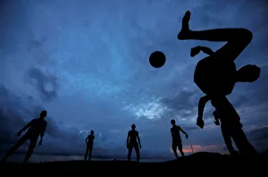 A boy kicks a ball as he plays soccer with his friends at Galle Dutch Fort in Galle A boy kicks a ball as he plays soccer with his friends at Galle Dutch Fort in Galle