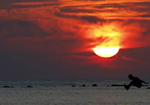 Boy is silhouetted as he jumps into the sea at a beach in the city of Durres Boy is silhouetted as he jumps into the sea at a beach in the city of Durres
