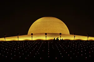 Buddhist monks hold candles and pray at the Wat Phra Dhammakaya temple in Pathum Thani province Buddhist monks hold candles and pray at the Wat Phra Dhammakaya temple in Pathum Thani province