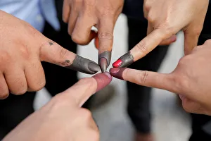Cambodian voters take pictures of their ink stained fingers after they voted Cambodian voters take pictures of their ink stained fingers after they voted