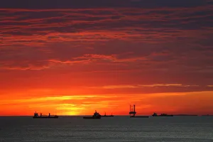 Cargo ships and an offshore supply vessel lie at anchor at sunrise off Sousse Cargo ships and an offshore supply vessel lie at anchor at sunrise off Sousse