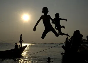 Children jump into the sea at Marunda beach in Jakarta Children jump into the sea at Marunda beach in Jakarta