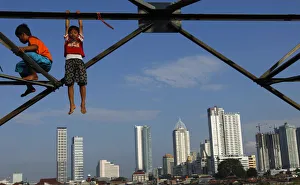 Children play at an electricity pylon in Jakarta Children play at an electricity pylon in Jakarta