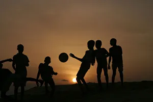 Children playing soccer are silhouetted at sunset in Nigerias main city of Lago Children playing soccer are silhouetted at sunset in Nigerias main city of Lago
