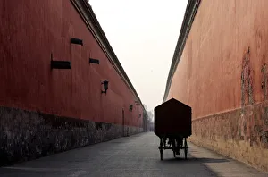 A Chinese cyclist pedals inside the Forbidden City in Beijing A Chinese cyclist pedals inside the Forbidden City in Beijing