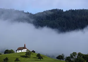 A church is pictured in the early morning on a mountain in Sarnen A church is pictured in the early morning on a mountain in Sarnen