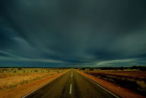 CLOUDS GATHER OVER PETERMANN ROAD IN CENTRAL AUSTRALIA CLOUDS GATHER OVER PETERMANN ROAD IN CENTRAL AUSTRALIA